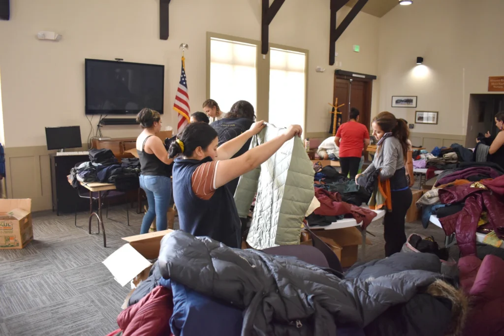 A group of members participate at a clothing distribution at a local church