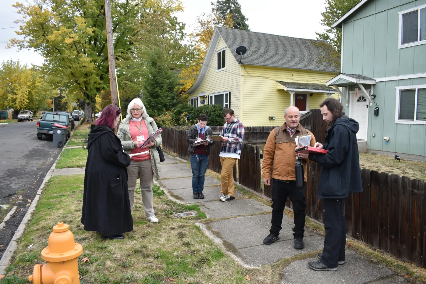 A total of six people, three teams of two, review forms in preparation for a membership canvass.